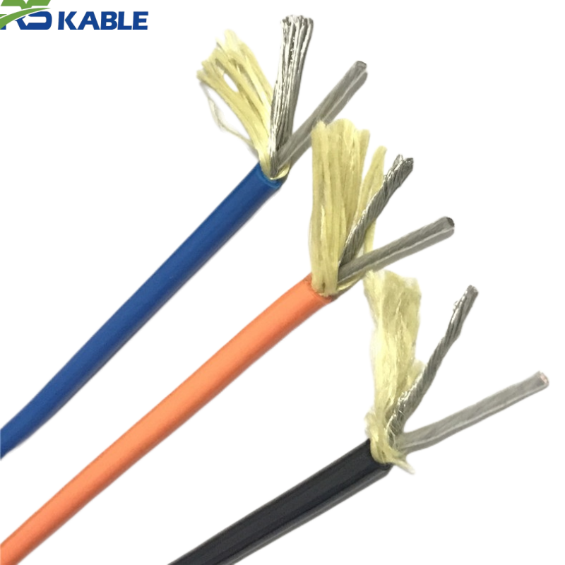 Cable conductors and aramid strength member Stripped cable end showing blue, orange, and black insulated conductors with yellow aramid strength member yarn